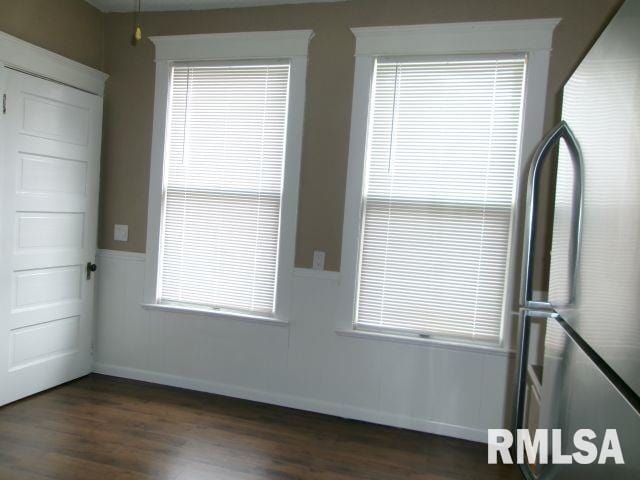 1209 S 4th St, Pekin, IL 61554 - unfurnished room featuring dark wood-style flooring and a wainscoted wall