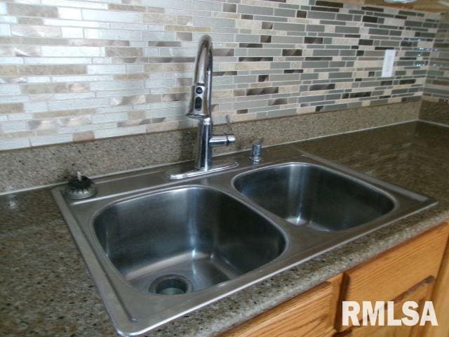 1209 S 4th St, Pekin, IL 61554 - kitchen view of decorative backsplash and brown cabinetry