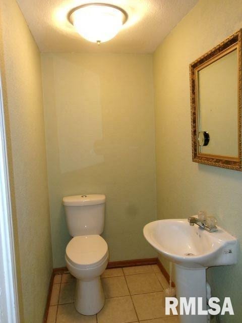 1209 S 4th St, Pekin, IL 61554 - half bathroom featuring toilet and tile patterned flooring