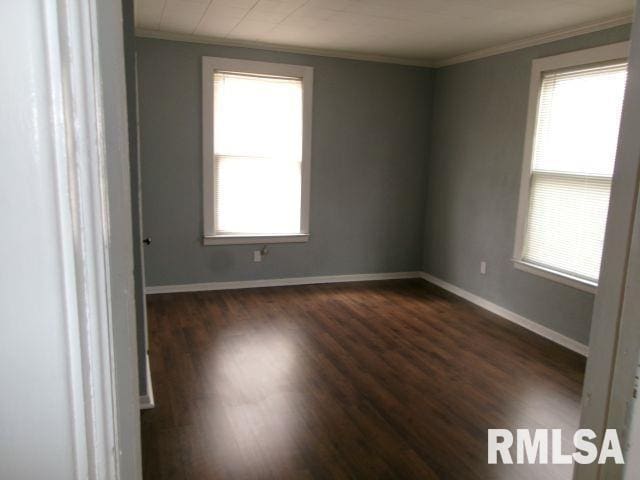 1209 S 4th St, Pekin, IL 61554 - empty room featuring crown molding, healthy amount of natural light, and dark wood finished floors