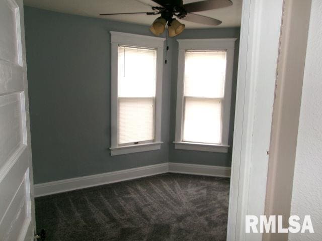 1209 S 4th St, Pekin, IL 61554 - unfurnished room with dark colored carpet, ceiling fan, and healthy amount of natural light