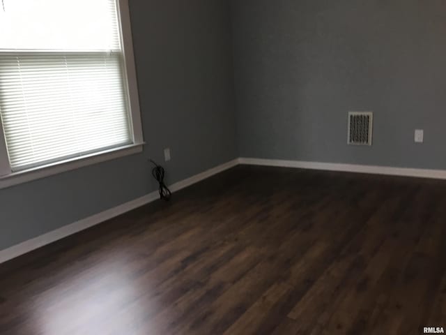 1209 S 4th St, Pekin, IL 61554 - spare room with dark wood-style flooring and baseboards