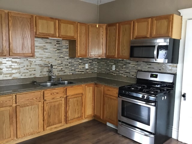 1209 S 4th St, Pekin, IL 61554 - kitchen featuring stainless steel appliances, dark countertops, tasteful backsplash, and dark wood-type flooring