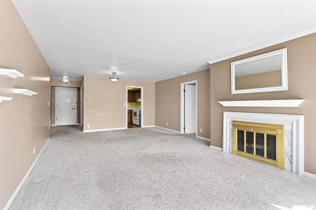 unfurnished living room featuring baseboards, carpet floors, and a fireplace