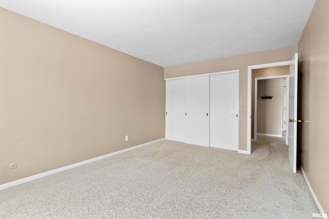 unfurnished bedroom with baseboards, a closet, and carpet floors