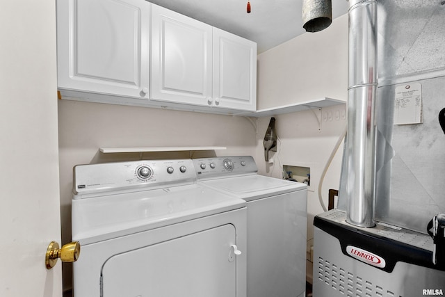 washroom with washing machine and dryer and cabinet space