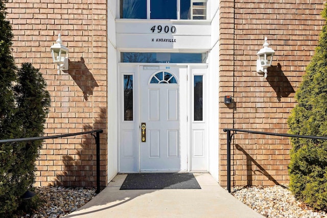 property entrance featuring brick siding