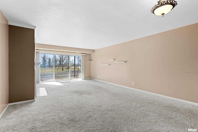 empty room featuring baseboards and carpet flooring