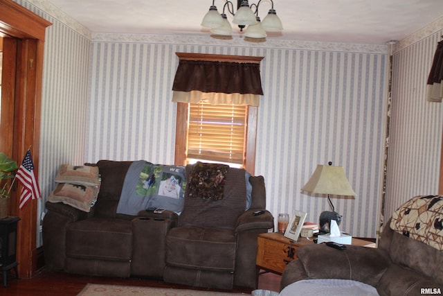 living area with wallpapered walls, wood finished floors, and a chandelier