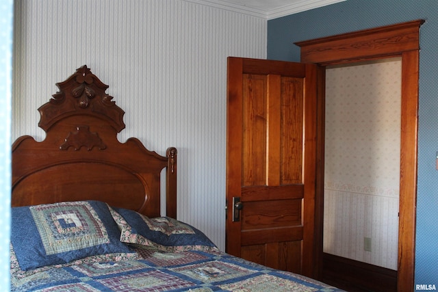bedroom featuring wallpapered walls and crown molding