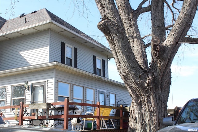 exterior space with a shingled roof