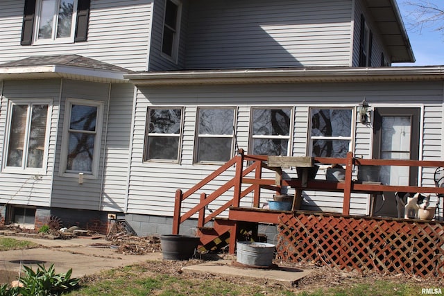 rear view of house featuring a deck