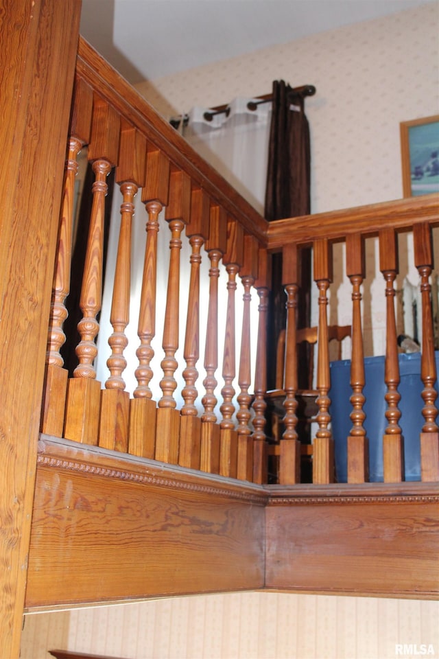 stairway with wallpapered walls