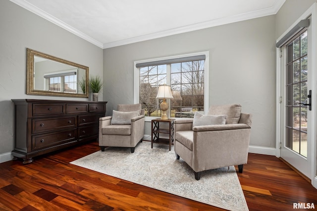 sitting room with dark wood finished floors, a healthy amount of sunlight, and baseboards