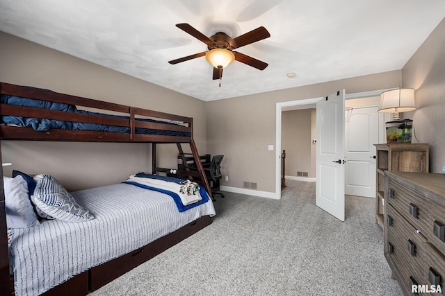 carpeted bedroom featuring baseboards, visible vents, and ceiling fan