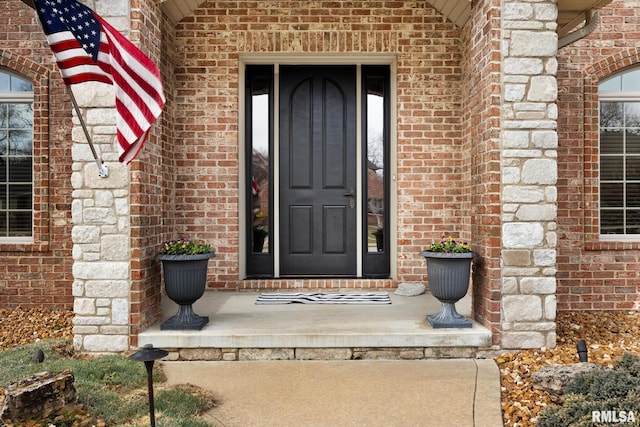 doorway to property with brick siding