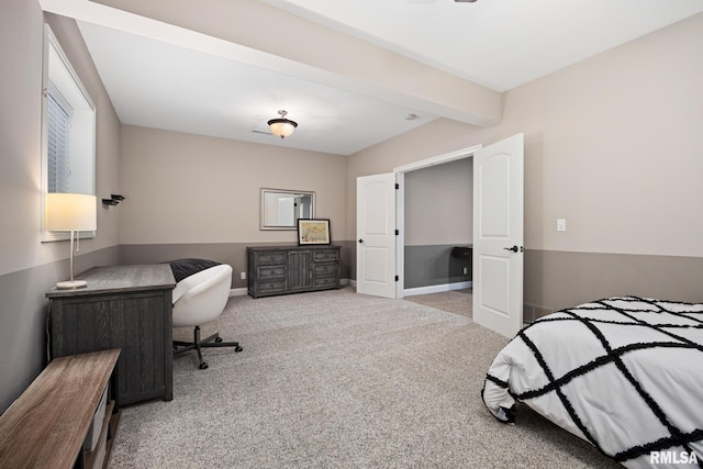 bedroom featuring baseboards, beam ceiling, and carpet flooring