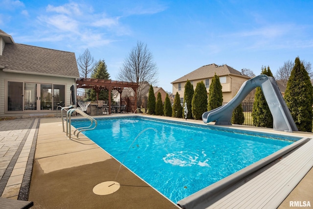 view of pool featuring a patio area, a fenced in pool, a water slide, and a pergola
