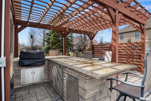 view of patio / terrace featuring a pergola, fence, grilling area, outdoor wet bar, and an outdoor kitchen