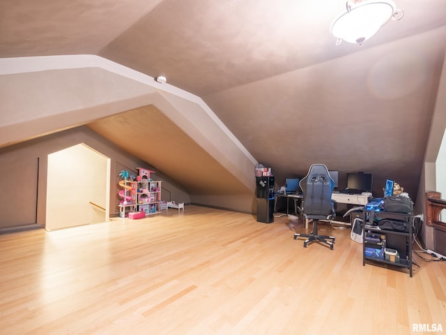 bonus room with lofted ceiling and wood finished floors