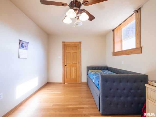 bedroom with baseboards, light wood-style flooring, and ceiling fan
