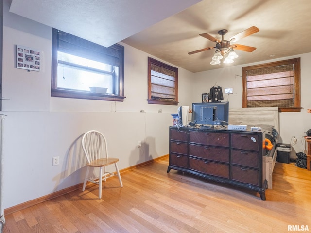 bedroom with baseboards, a ceiling fan, and light wood-type flooring