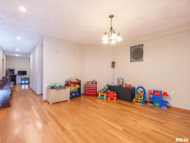 rec room featuring a chandelier, recessed lighting, and light wood-type flooring