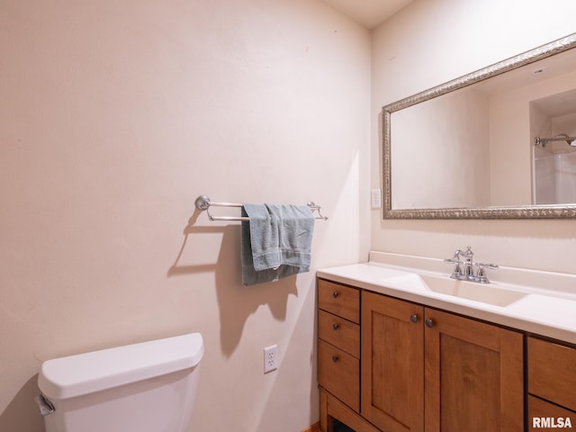 bathroom featuring toilet and vanity
