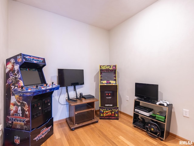 playroom featuring baseboards and wood finished floors
