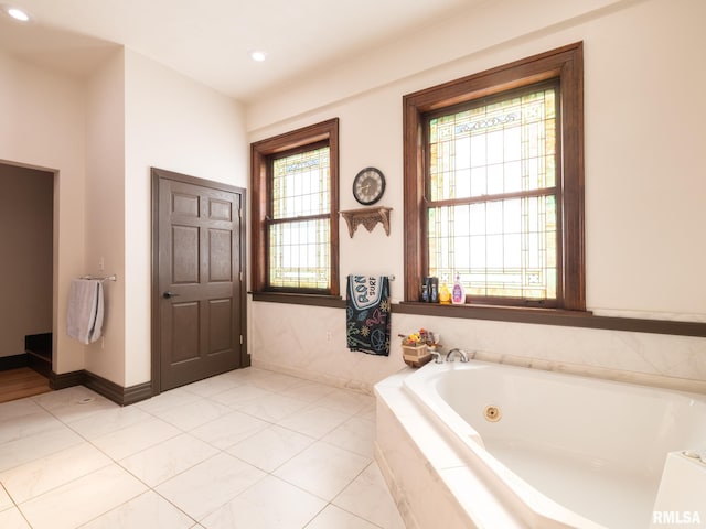 bathroom featuring baseboards, recessed lighting, tile patterned flooring, and a jetted tub