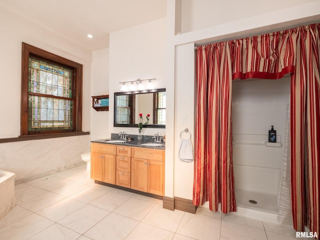full bathroom featuring double vanity, a wealth of natural light, a sink, and a shower with shower curtain