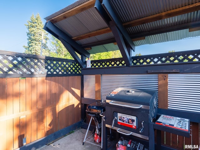 view of patio with a grill and fence