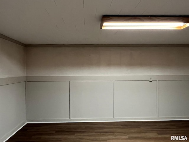 detailed view of wood finished floors and a decorative wall