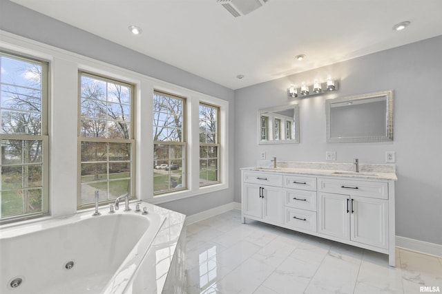 949 NE Glen Oak Ave, Peoria, IL 61603 - bathroom featuring marble finish floor, a sink, a whirlpool tub, and baseboards