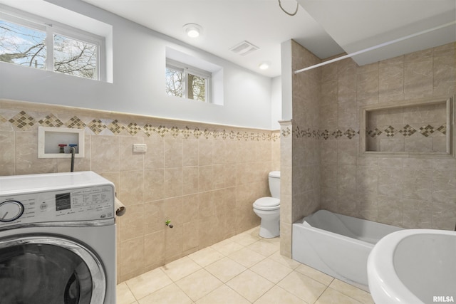 949 NE Glen Oak Ave, Peoria, IL 61603 - bathroom featuring visible vents, tile walls, toilet, washer / dryer, and tile patterned flooring