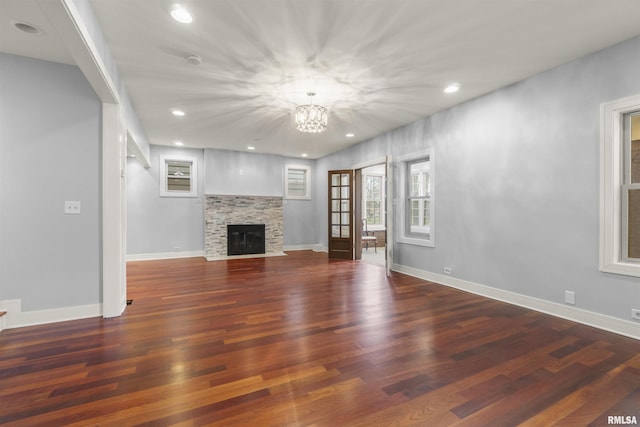 949 NE Glen Oak Ave, Peoria, IL 61603 - unfurnished living room with a chandelier, wood finished floors, baseboards, and recessed lighting