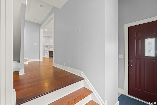 949 NE Glen Oak Ave, Peoria, IL 61603 - entryway featuring a stone fireplace, baseboards, and wood finished floors