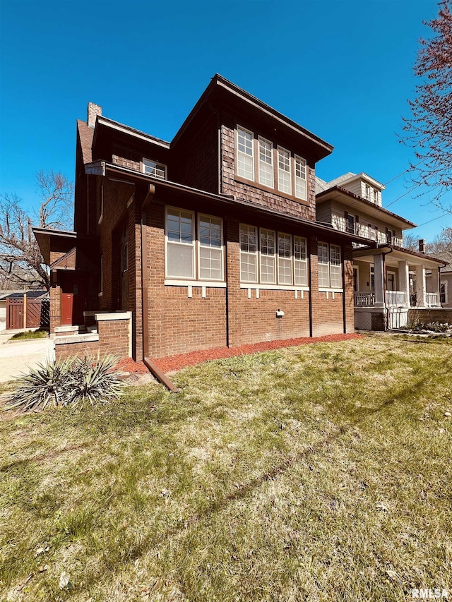 949 NE Glen Oak Ave, Peoria, IL 61603 - rear view of property with a chimney, a lawn, and brick siding
