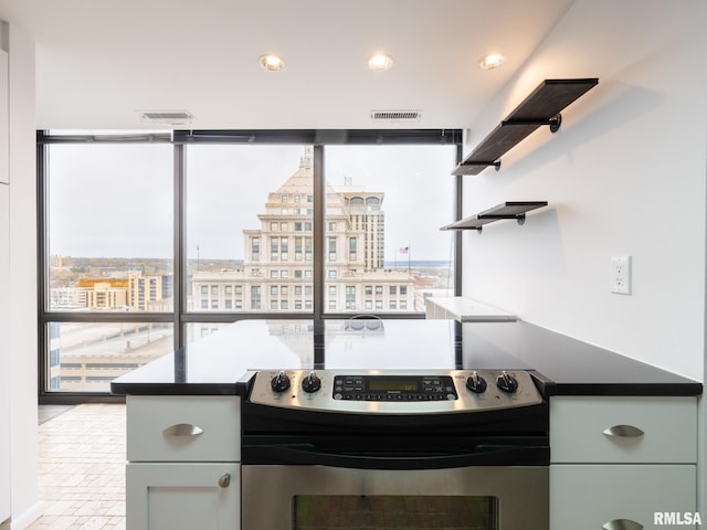 kitchen with visible vents, floor to ceiling windows, recessed lighting, stainless steel range with electric cooktop, and open shelves
