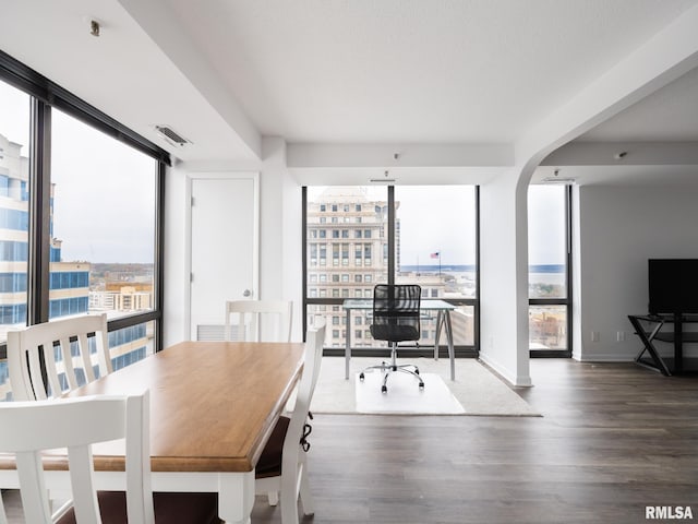 dining area with a wealth of natural light, expansive windows, and visible vents