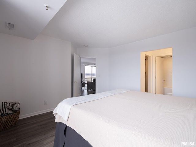 bedroom with dark wood-style floors and baseboards