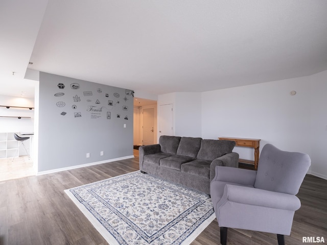 living area featuring dark wood-type flooring and baseboards