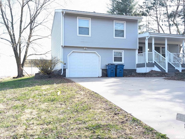 301 E Vine St, San Jose, IL 62682 - view of front of home with an attached garage, concrete driveway, and a porch