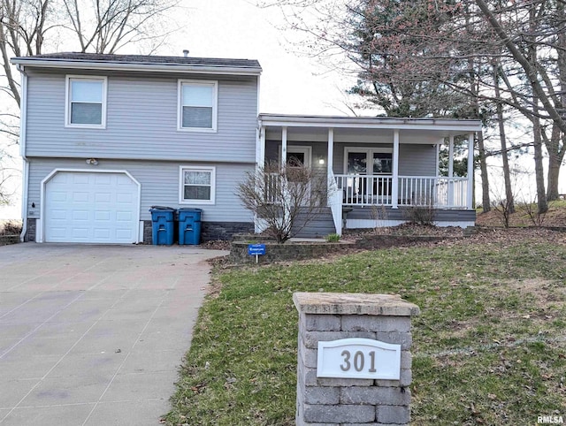 301 E Vine St, San Jose, IL 62682 - split level home featuring a porch, driveway, an attached garage, and a front lawn