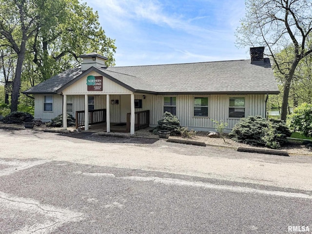 10 Locust Grove Ct, Groveland, IL 61535 - view of front facade with roof with shingles, a chimney, and a porch