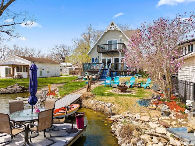 1800 Mitchell St, Pekin, IL 61554 - rear view of house featuring a balcony, a fire pit, a deck, and a lawn