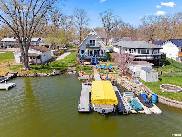 1800 Mitchell St, Pekin, IL 61554 - view of dock featuring a fire pit, a fenced backyard, a residential view, a deck with water view, and a yard