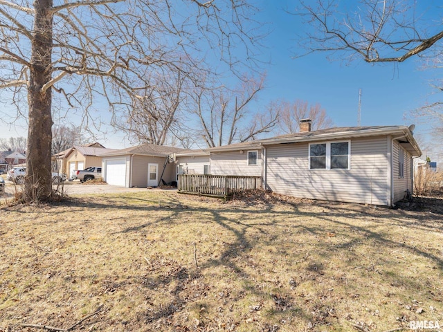102 S Van Buren St, Lewistown, IL 61542 - back of house featuring a chimney, a wooden deck, an attached garage, and a yard