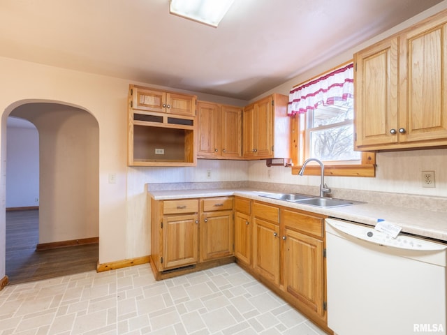 102 S Van Buren St, Lewistown, IL 61542 - kitchen with light countertops, baseboards, arched walkways, a sink, and white dishwasher