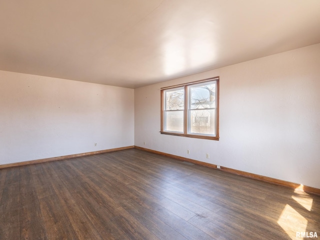 102 S Van Buren St, Lewistown, IL 61542 - empty room with baseboards and dark wood finished floors